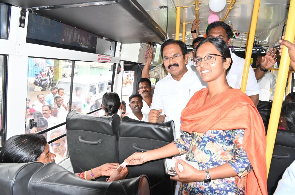 Politicians distributing bus tickets to women in March 2024.